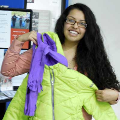 Huskie Service Scholar Shareny Mota sorts coats for Homelessness and Hunger Week.