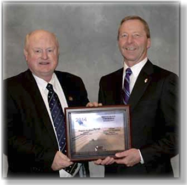 Mark Tuttle represented DeKalb County Farm Bureau in special recognition at the Illinois Farm Bureau Annual Meeting, accepting a plaque from IFB Vice President Dave Erickson. Tuttle proudly reported, “It was another good year for the DeKalb County Farm Bureau.”