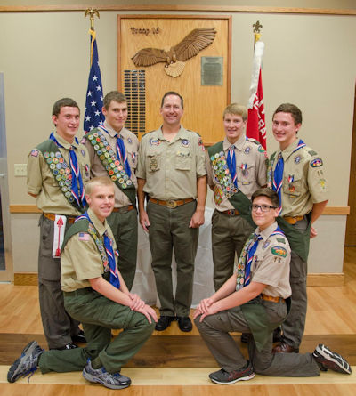 Pictured here are the newest Eagle Scouts in Troop 16. Left to right: Chris Meyer (kneeling), David Ruetten, Keagon Larsen, Scoutmaster Dr. Tim Ruetten, Preston Ruud, Paul Ruetten, and Matt Slider (kneeling). Photo provided by Danika Marie Photography